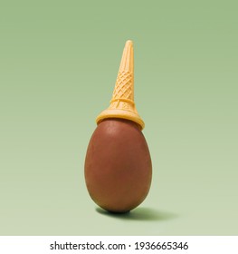 One Big Fair Trade Milk Chocolate Egg With Ice Cream Cone On Top Arrangement. Calm Green Background