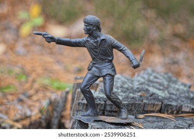 one big old dirty brown toy soldier stands on a gray stump in the street - Powered by Shutterstock