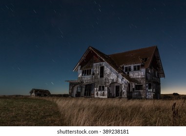 One Big Old House That Is Very Run Down At Night.