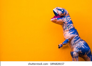 one big and tall dinosaur enjoying and having fun with orange background - copy and blank space to write your text here
