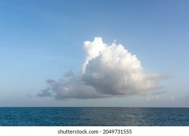 One Big White Cloud In Blue Sky Over Sea Landscape. Cloud Above Ocean Water Panorama, Horizon, Beautiful Tropical Caribbean Summer Day Seascape Panoramic View, Cloudy Weather With Copy Space