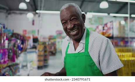 One Black Brazilian Senior Employee of Supermarket with Tablet, Inside Grocery Store. Portrait close-up face of an African American person at workplace - Powered by Shutterstock