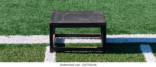 One Black Metal Plyo Box On A Green Turf Field.