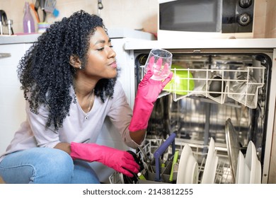 One Black Woman Checking Broken Dishwasher At Home