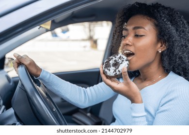 One Black Woman Smiling Eating A Doughnut