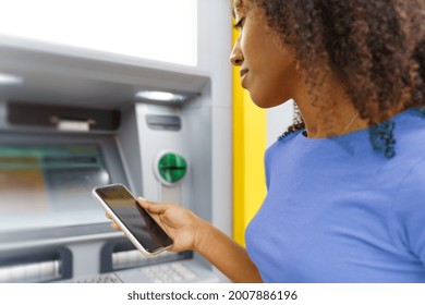 One Black Woman Withdrawing Money At An Atm