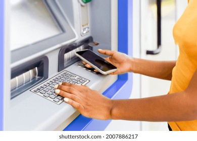 One Black Woman Withdrawing Money At An Atm