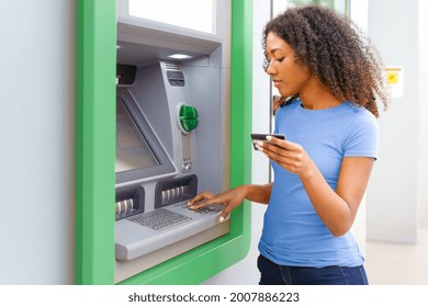 One Black Woman Withdrawing Money At An Atm