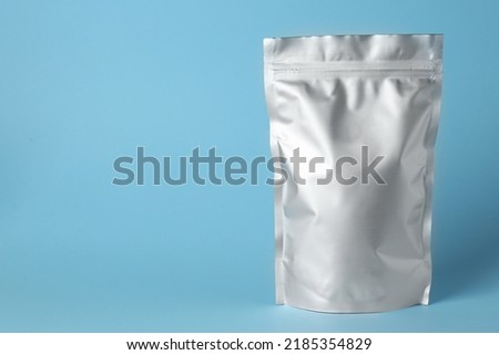 One blank foil package on light blue background. Space for text