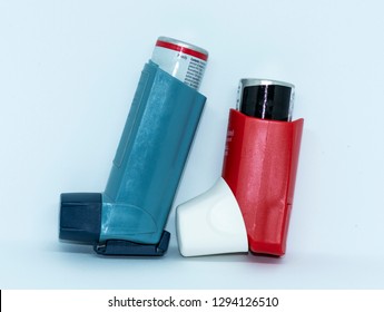 One Blue And One Red Athma Rescue Inhaler Standing Up With A White Background.