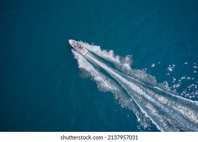 One boat on blue water drone view. Modern boat in motion making a trail on the water top view. Boat moving fast aerial view. - Powered by Shutterstock
