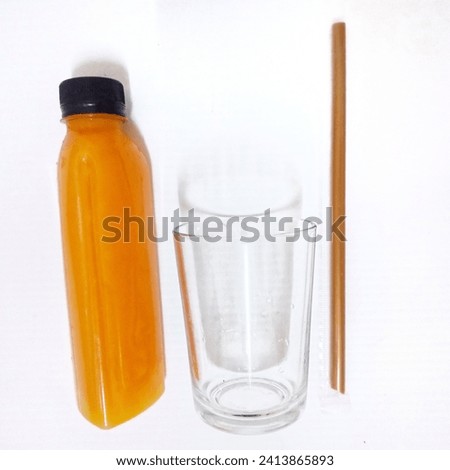 One a bottle of freshly squeezed orange juice with  a glass of water and drinking straw onwhite background.