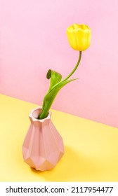 One Bright Yellow Tulip In Art Vase On Pastel Two Tone Yellow-pink. Creative Minimal Greeting Card.