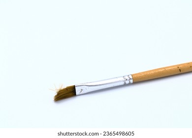 One brush. Ready to paint again.  Light wooden handle. White background. - Shutterstock ID 2365498605