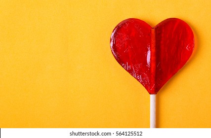 One Candy Heart Shape On Yellow Background