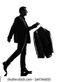 One Caucasian Business Man Holding Dry Clean Clothes In Silhouette  On White Background