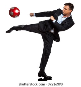 One Caucasian Business Man Playing Kicking Soccer Ball In Studio Isolated On White Background