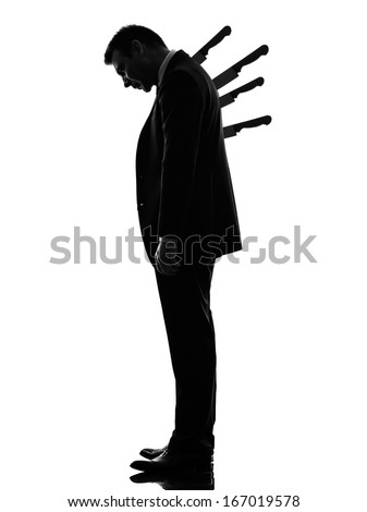 one caucasian business man Stabbed in the Back in silhouette  on white background
