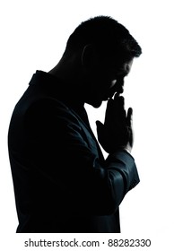 one caucasian business man thinking praying  portrait silhouette in studio isolated on white background