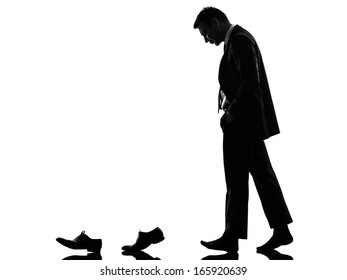 One Caucasian Business Man Walking Behind His Shoes   In Silhouette  On White Background