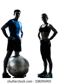 One Caucasian Couple Man Woman Personal Trainer Coach Exercising Fitness Ball Silhouette Studio Isolated On White Background