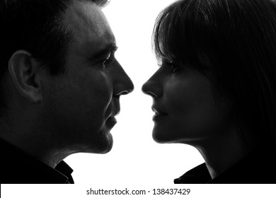 One Caucasian Couple Woman Man Face To Face In Silhouette Studio Isolated On White Background