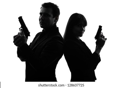 one caucasian man detective secret agent criminal  with gun  in silhouette studio isolated on white background