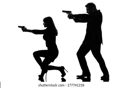 one caucasian man detective secret agent criminal with gun in silhouette studio isolated on white background
