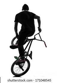 one caucasian man exercising bmx acrobatic figure in silhouette studio isolated on white background
