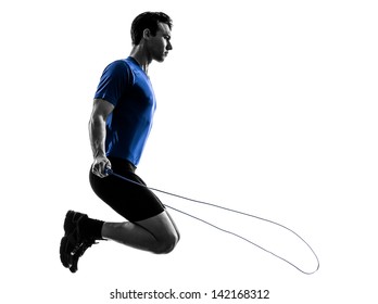 One Caucasian Man Exercising Jumping Rope In Silhouette Studio  On White Background