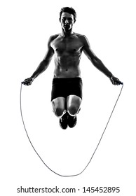 One Caucasian Man Exercising Jumping Rope In Silhouette Studio  On White Background