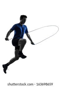 One Caucasian Man Exercising Jumping Rope In Silhouette Studio On White Background