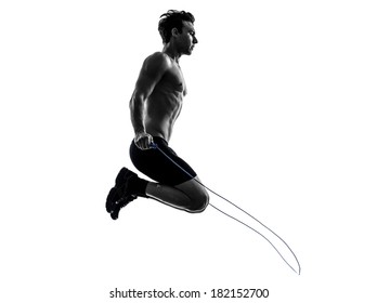 One Caucasian Man Exercising Jumping Rope In Silhouette Studio On White Background