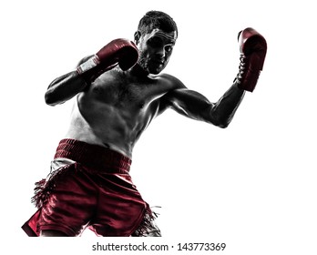 one caucasian man exercising thai boxing in silhouette studio  on white background