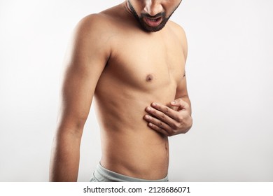 One Caucasian Man Feeling Severe Pain In His Rib Cage With Worried Face. Isolated In White Background.