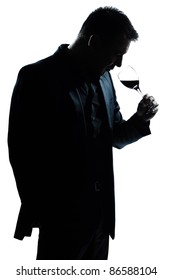 one caucasian man portrait silhouette smelling red wine glass in studio isolated white background