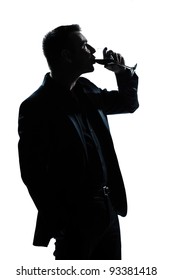 One Caucasian Man Portrait Silhouette Drinking Red Wine In Studio Isolated White Background