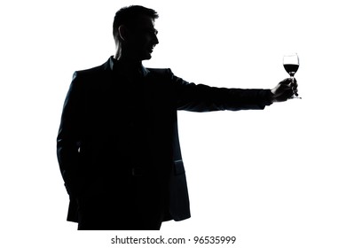 one caucasian man portrait silhouette rising up toasting his glass of red wine in studio isolated white background