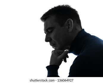 One Caucasian Man Serious Thinking Pensive Portrait In Silhouette Studio Isolated On White Background