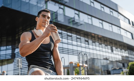 One caucasian man young male athlete take a brake during outdoor training in the park outdoor gym hold supplement shaker in hand happy confident strong copy space - Powered by Shutterstock