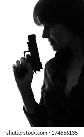 One Caucasian Sexy Detective Woman Holding Aiming Gun In Silhouette Studio Isolated On White Background