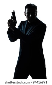 one caucasian spy criminal policeman detective man holding gun portrait silhouette in studio isolated white background