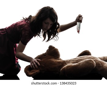 one caucasian strange young woman killing her teddy bear  in silhouette white background