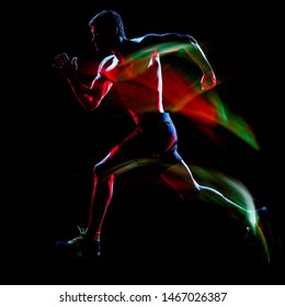 One Caucasian Topless Muscular Mature Man Runner. Running Jogger Jogging Isolated On Black Background With Light Painting Speed Mouvement Effect