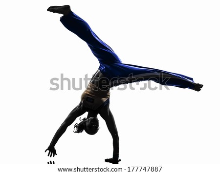 one caucasian woman capoeira dancer dancing in silhouette studio isolated on white background