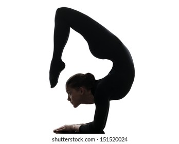 one caucasian woman contortionist practicing gymnastic yoga  in silhouette   on white background