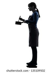 One Caucasian Woman Cooking Mixing Saucepan In Silhouette Studio Isolated On White Background