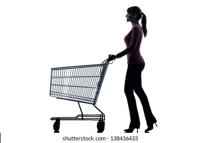 One Caucasian Woman With Empty Shopping Cart In Silhouette Studio Isolated On White Background