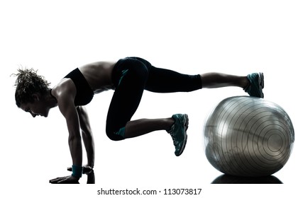 One Caucasian Woman Exercising Fitness Ball Workout Posture In Silhouette Studio Isolated On White Background