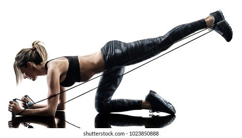 one caucasian woman exercising pilates fitness  elastic resistant band exercises isolated  silhouette on white background